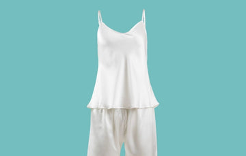 Ameline Ava Pearly White lustrious 100% Mulberry Silk Camisole Short Pajama Set, against blue background
