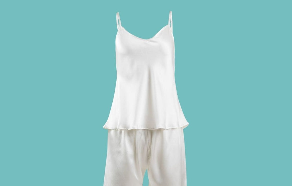 Ameline Ava Pearly White lustrious 100% Mulberry Silk Camisole Short Pajama Set, against blue background