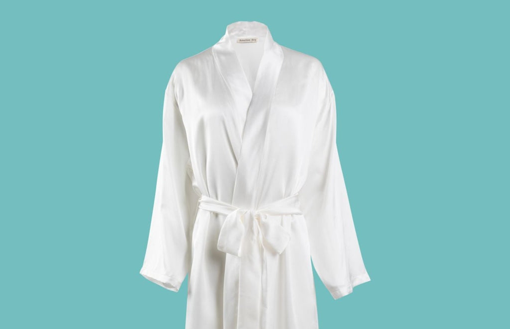 Ameline Ava Pearly White lustrious 100% Mulberry Silk Mid Length Robe, against blue background